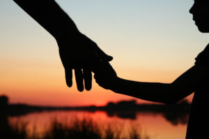 Family Lawyer Modesto, CA - silhouette parent and child hands
