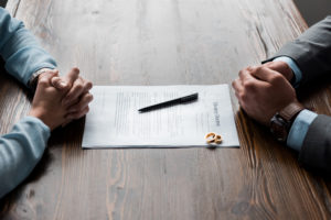 collaborative divorce lawyer Modesto, CA - couple at table with divorce papers
